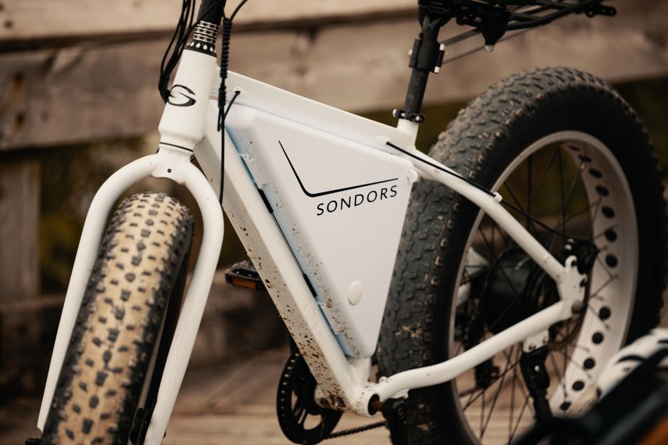 Close-up image of a Sondors electric bicycle with fat tires parked outdoors.